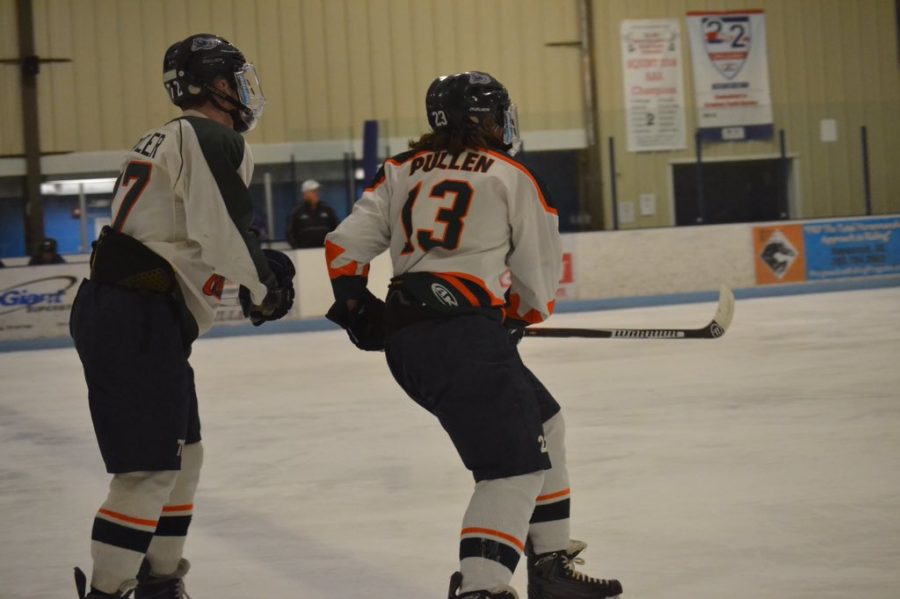 Junior Nathan Pullen skates past a teammate during the senior night game.