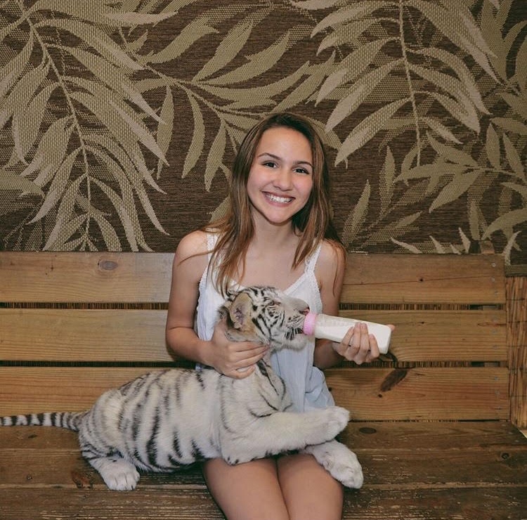 Loving her time with the baby tiger, Sara Rodriguez smiles for the camera. Rodriguez
met the tiger at a preservation in Myrtle Beach.