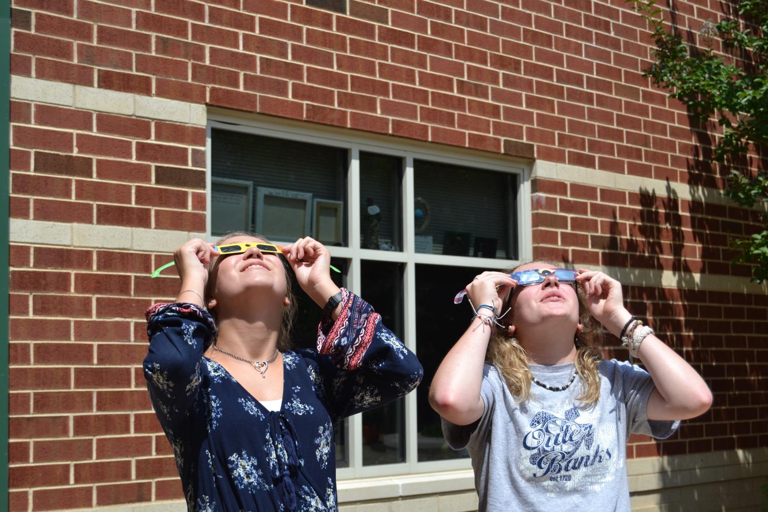 Students take a look up to the sky, trying to catch a glimpse of the solar eclipse. 