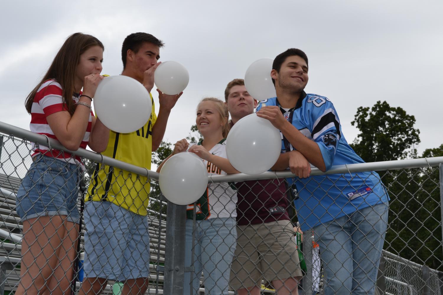 Students hang out after school decorating The Cage. 