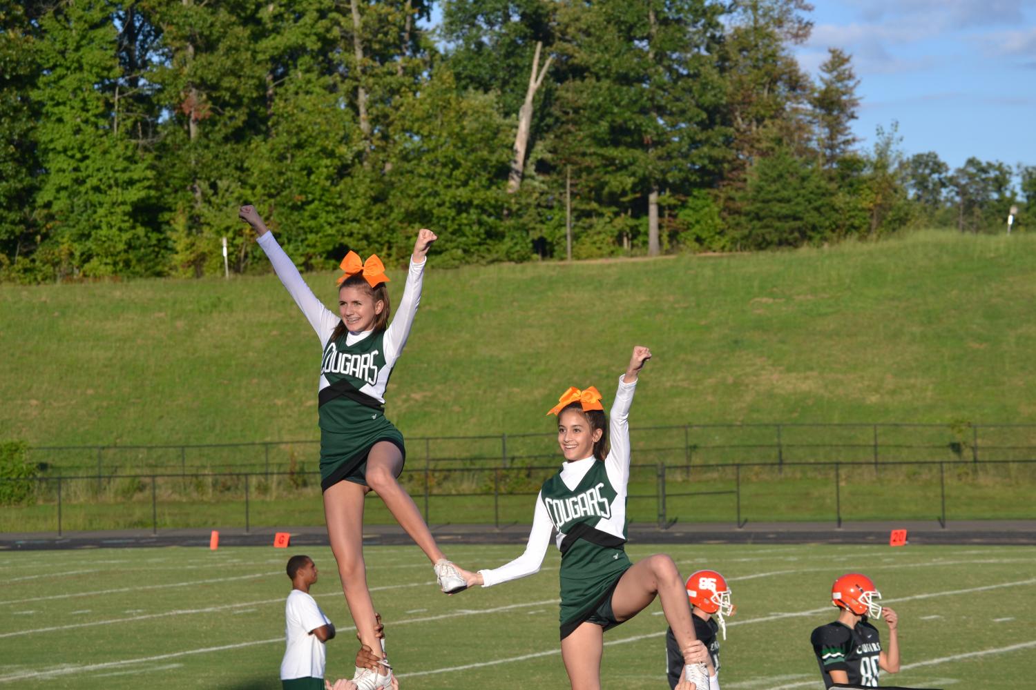 JV Cheerleaders hype up the crowd during a JV Football game. 