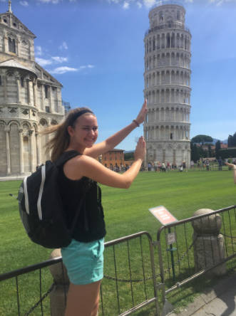 Sarah Hume takes a fun photo next to the Leaning Tower of Piza