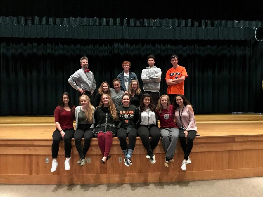 Sitting on the stage, the cast takes a picture before their big night.