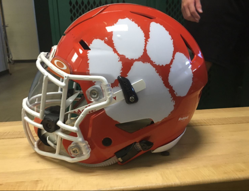 Before a game, senior Andrew Picketts helmet sits on a locker room bench.