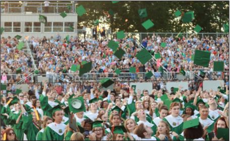 Celebrating their educational achievements, members of the class of 2017 throw their caps in the air as the officially become Kettle Run alumni. 