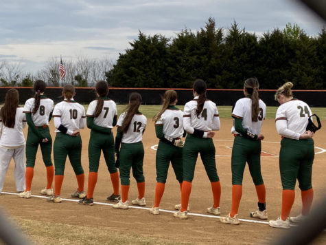 Varsity softball standing for the National Anthem before their 9-4 win at Brentsville.