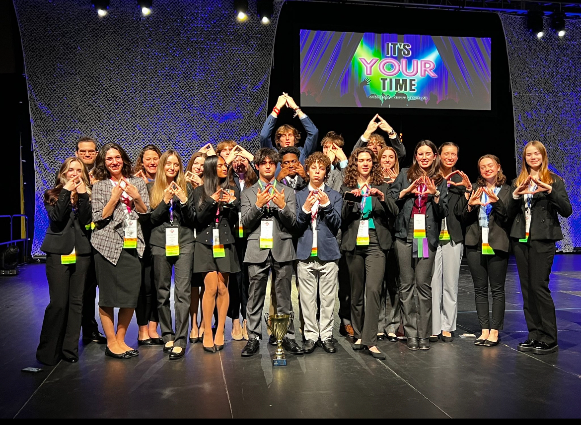 KRHS DECA students attending a conference and brought home the "W" (win).