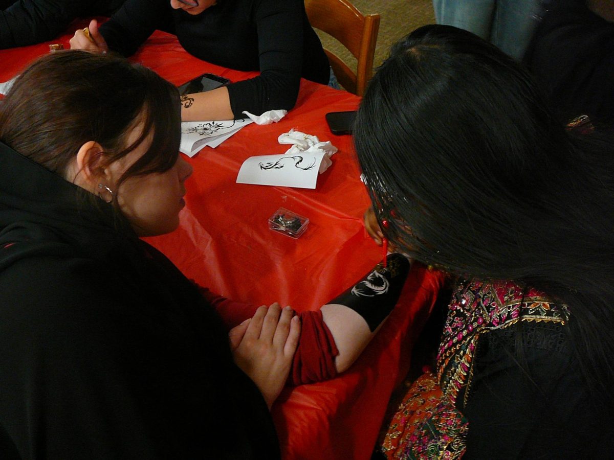 MSA students creating henna designs for other students.