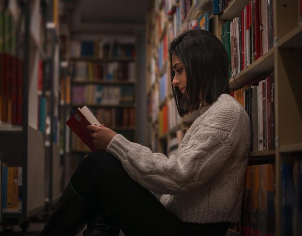 Girl reading a book at the library