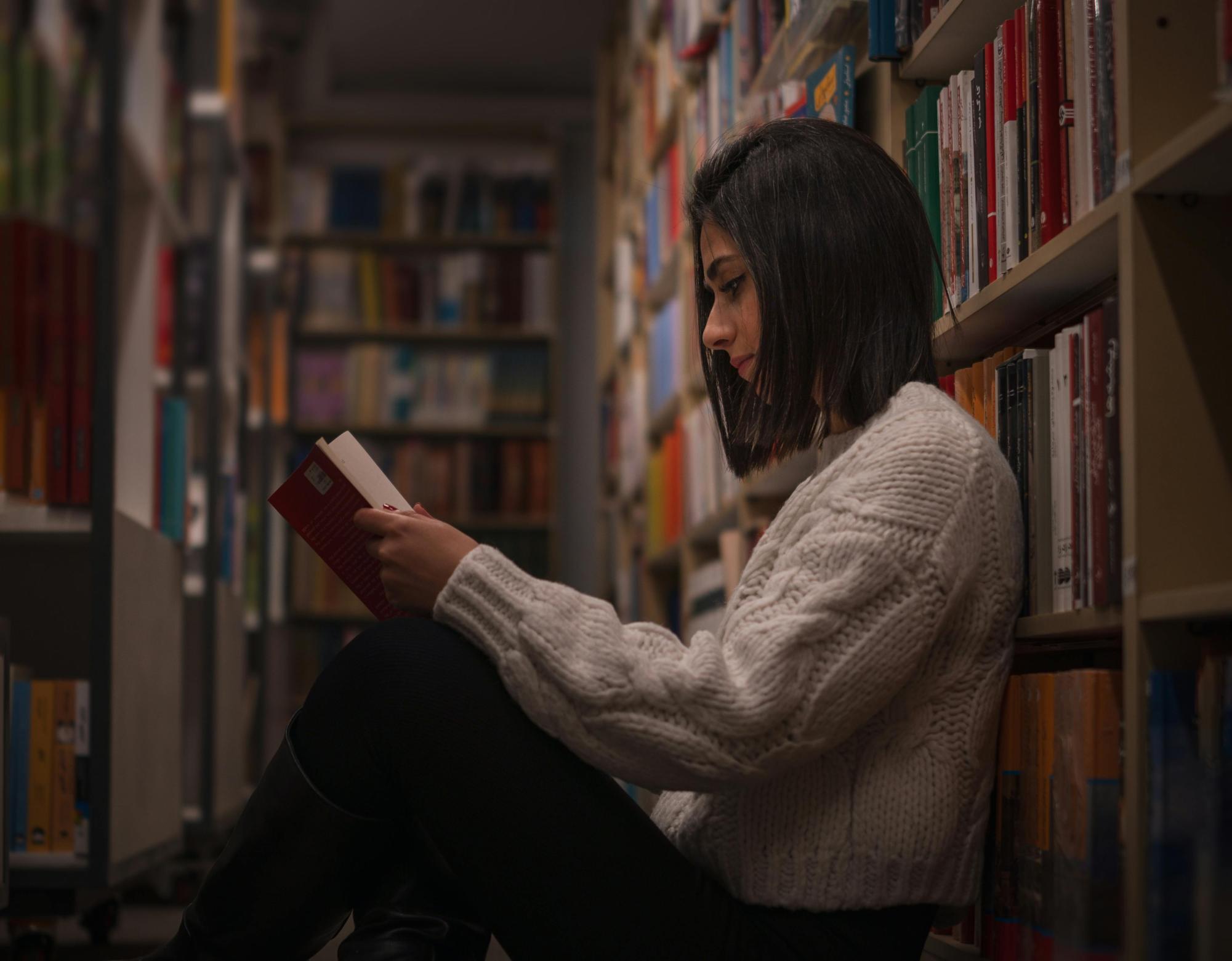 Girl reading a book at the library