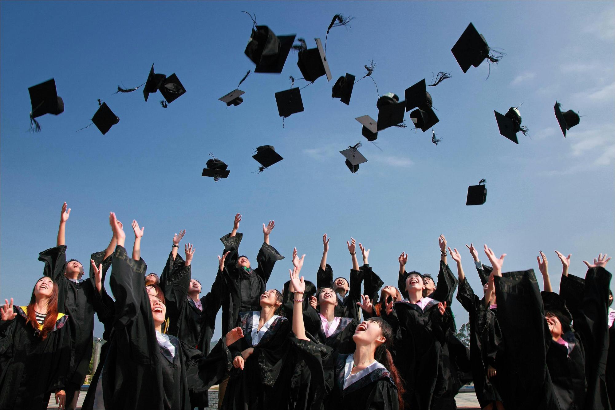 Graduation photo of students throwing up graduation caps!